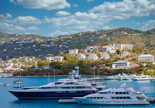 Giant luxury yachts at a tropical pier