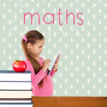 The word maths and cute girl using tablet against red apple on pile of books