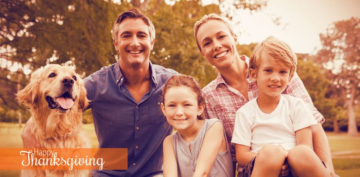 Thanksgiving greeting text against family enjoying with dog at park