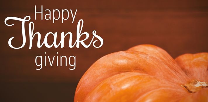 Thanksgiving greeting text against cropped image of pumpkin during halloween