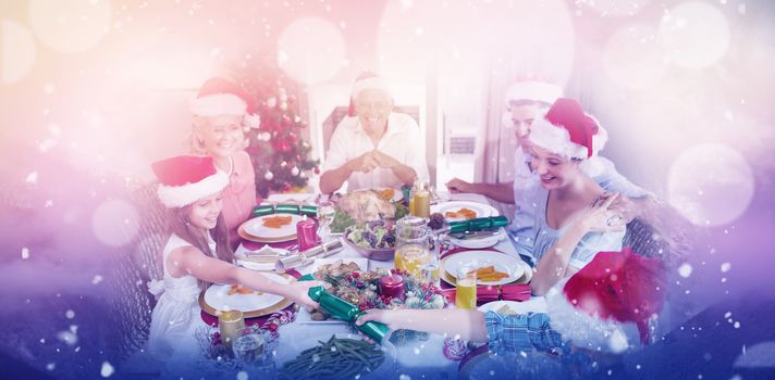 Cheerful family at dining table for christmas dinner against clouds covering snowcapped mountains against sky
