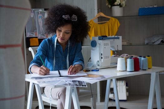 Female fashion designer working at desk in home