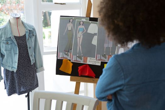 Female fashion standing near bulletin board at home