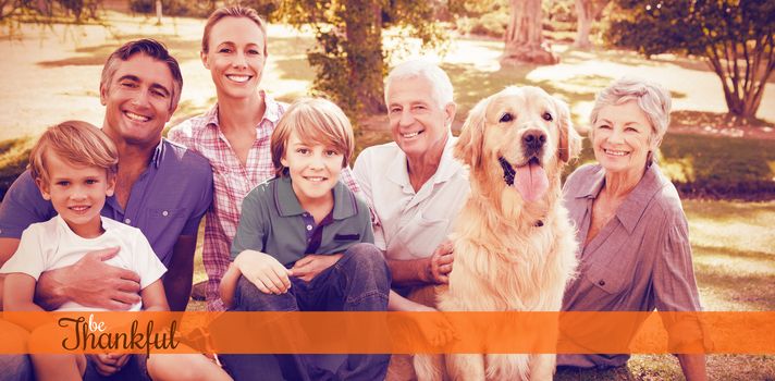 Thanksgiving greeting text against happy family smiling with dog