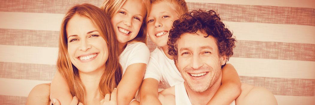 Portrait of joyful family on bed at home