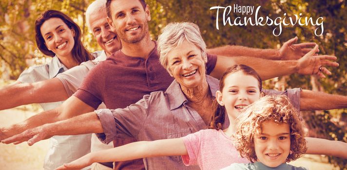 Illustration of happy thanksgiving day text greeting against extended family smiling in park