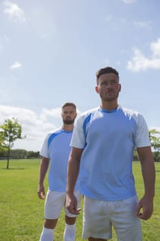 Football players standing in ready position on ground