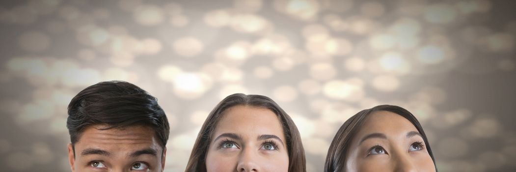 Digital composite of People looking up with sparkling background