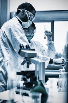 Chemists viewing liquids in the laboratory