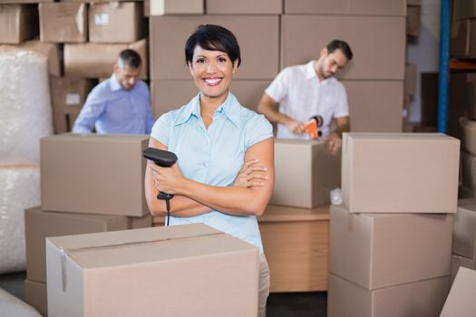 Warehouse workers preparing a shipment in a large warehouse