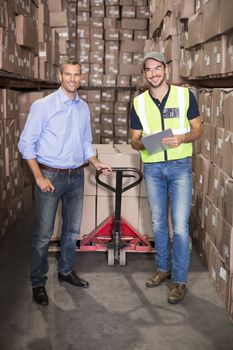 Warehouse manager and foreman working together in a large warehouse