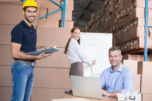 Warehouse team working together on shipment in a large warehouse