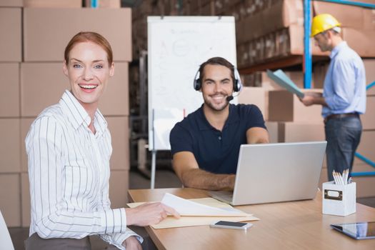 Warehouse team working together on shipment in a large warehouse