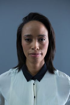Portrait of young female executive smiling in office