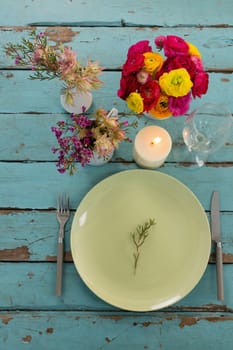 Overhead of table setting on weathered wooden plank
