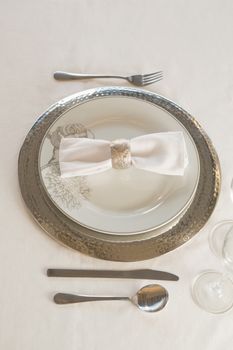Close-up of plate and cutlery set elegantly on a table