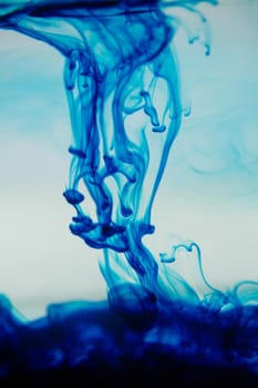 Close-up of blue ink spreading in the water