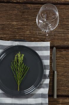 Overhead of elegance table setting with empty wine glass on wooden plank