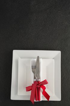 Close-up of table setting with square plates and cutlery