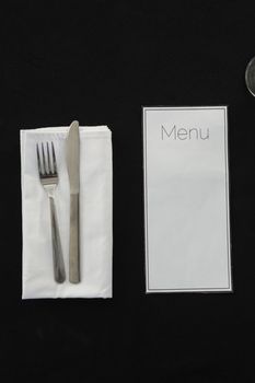 Black theme table setting with menu card
