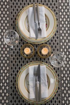 Overhead of elegance table setting with wine glasses on placemat