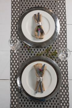 Overhead of elegance table setting with wine glasses on placemat