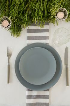 Overhead view of plate and cutlery set elegantly on a table