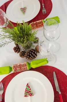 Overhead view of plate and cutlery set beautifully on Christmas theme