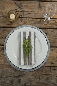 Overhead of elegance table setting on wooden plank