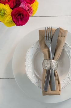 Ovehead of elegance table setting on wooden plank