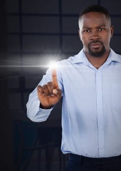 Digital composite of Businessman pointing touching air light glow