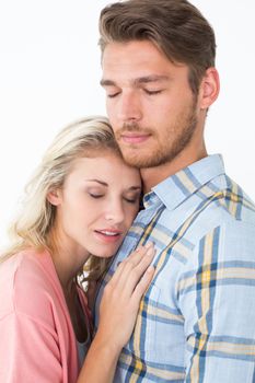 Close up of romantic young couple with eyes closed over white background