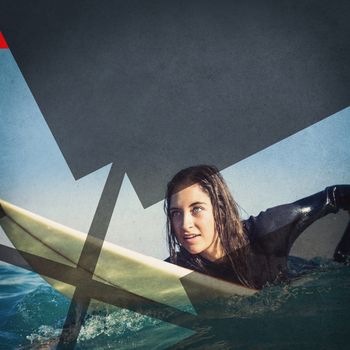 woman in wetsuit with a surfboard on a sunny day at the beach