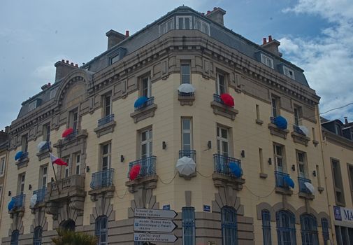 Building with umbrellas on every balcony in Cherbourg, France
