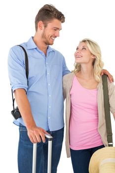 Attractive young couple ready to go on vacation over white background