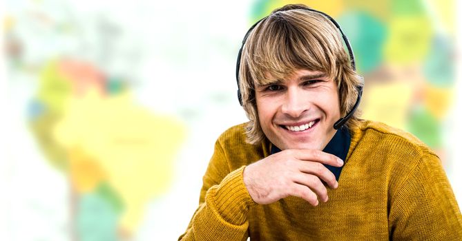 Digital composite of Travel agent man wearing headset in front of world map