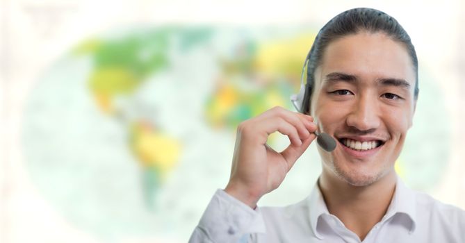 Digital composite of Travel agent man wearing headset in front of world map