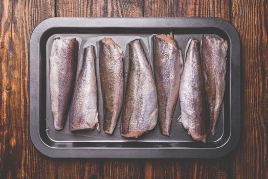 Hake carcasses on baking sheet. View from above