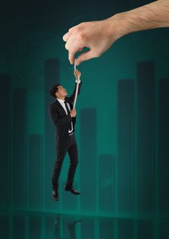 Digital composite of Hand choosing a man with a rope on a green background with graph