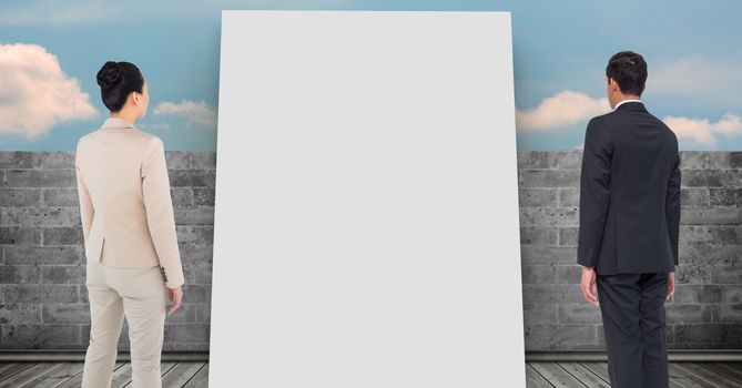 Digital composite of Business people looking at white board