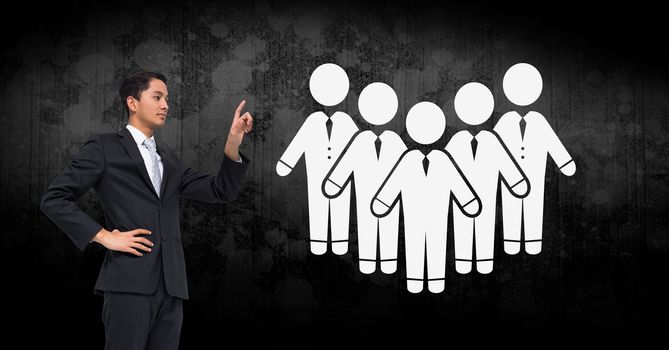 Digital composite of Businessman pointing at people group icons