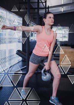 Digital composite of Athletic fit woman in gym with health interface