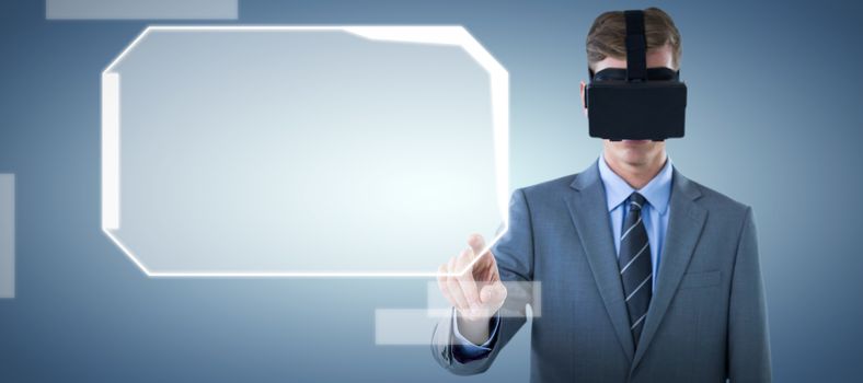 Businessman pointing finger while using virtual reality headset against abstract blue background