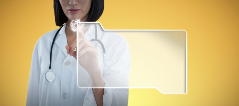 Mid section of female doctor touching invisible screen against abstract yellow background