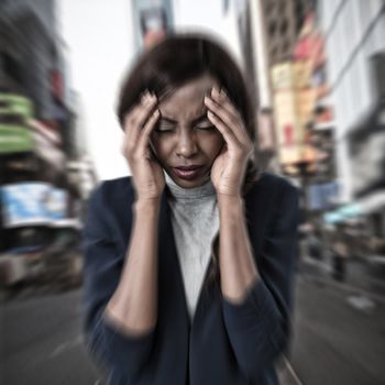 Businesswoman suffering from headache against picture of a city