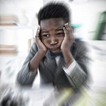 White background with vignette against businessman holding head while sitting with headache at desk