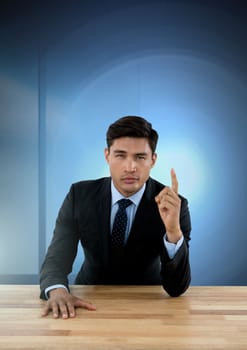Digital composite of Businessman working on desk with blue light source