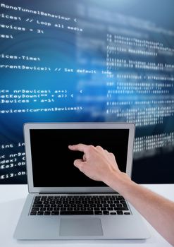 Digital composite of Hand touching laptop with coding text