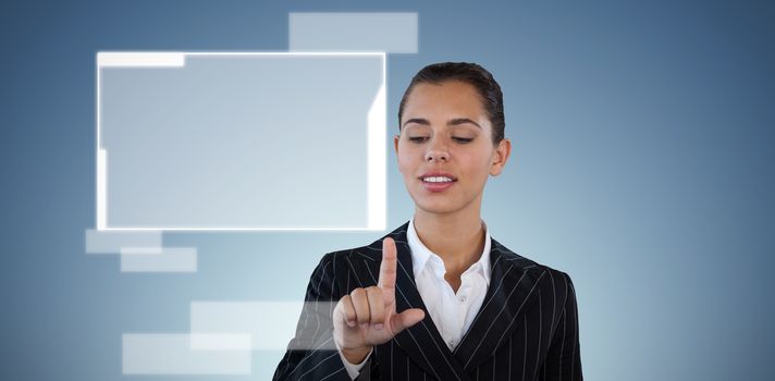 Businesswoman in suit touching invisible interface against abstract blue background