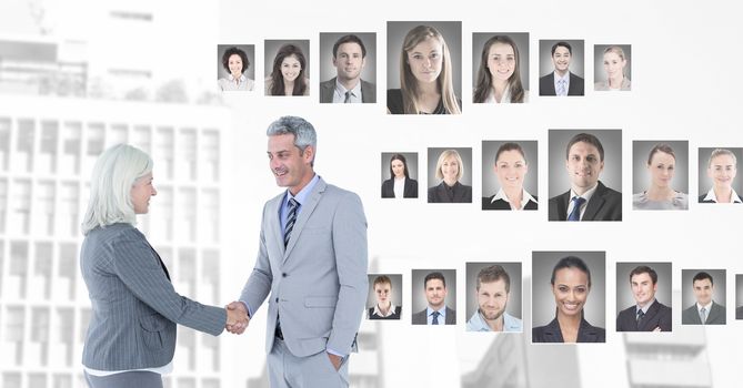 Digital composite of Business people shaking hands with portrait profiles of different people